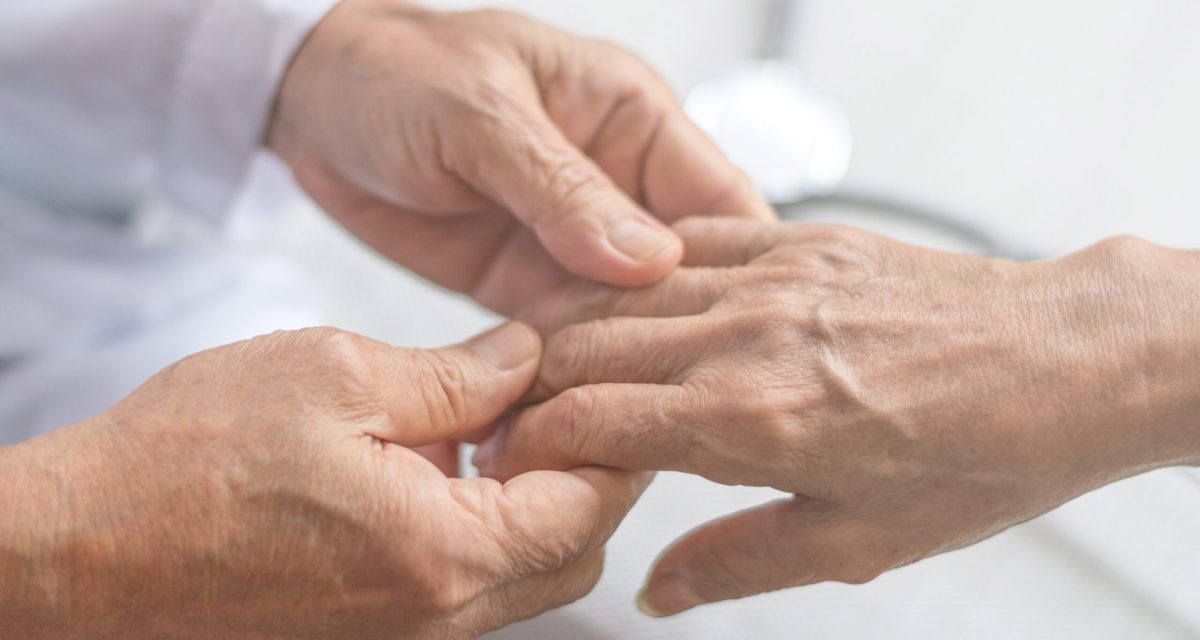 Geriatric doctor or geriatrician concept. Doctor physician hand on happy elderly senior patient to comfort in hospital examination room or hospice nursing home or wellbeing county.